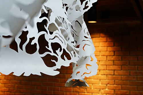 Fold/Unfold hand-cut Tyvek paper installation by Sukanya Mani